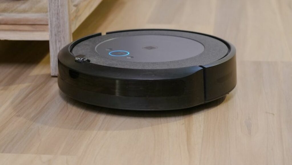 A robot vacuum on wooden floor
