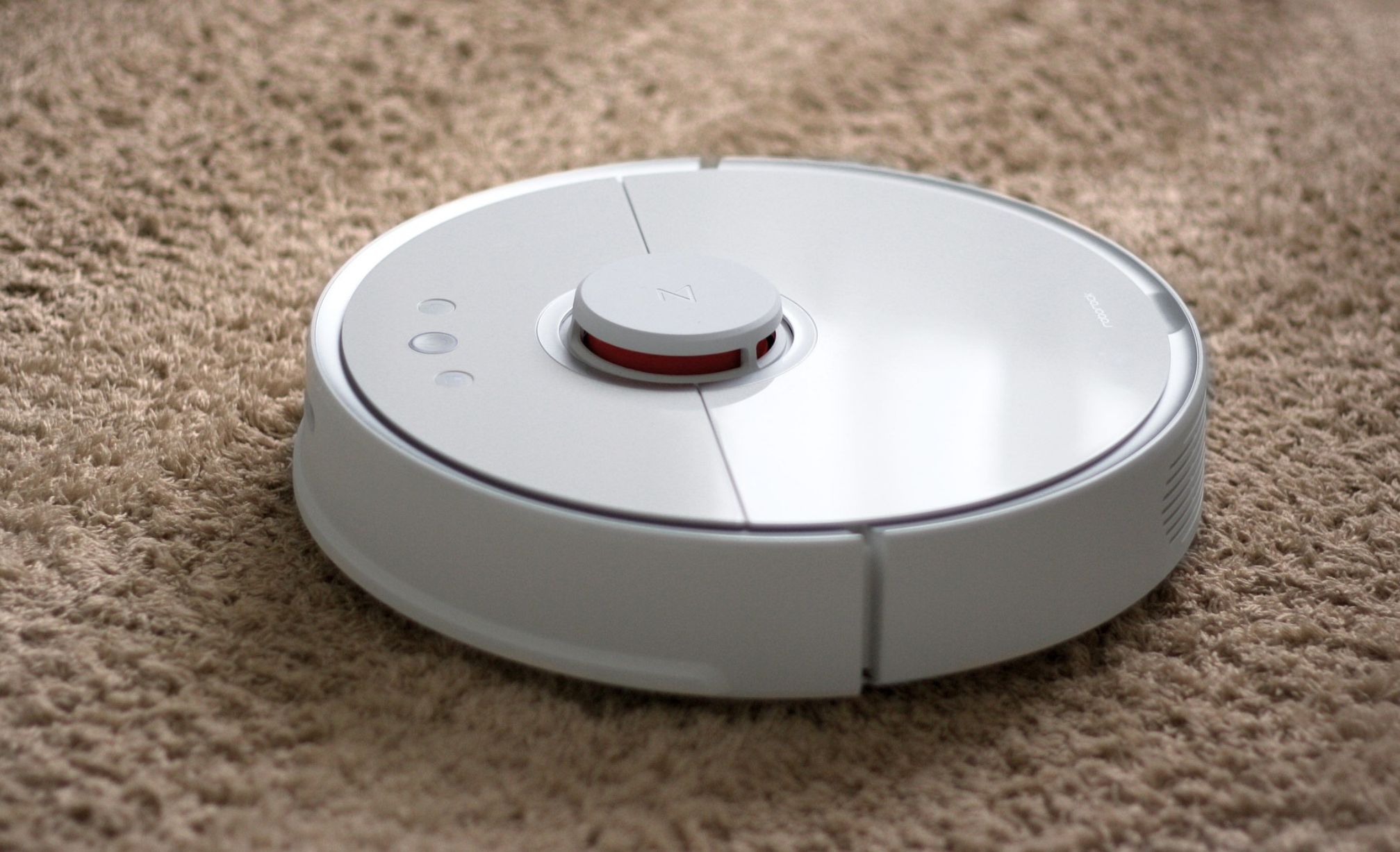 A robot vacuum cleaning a carpet
